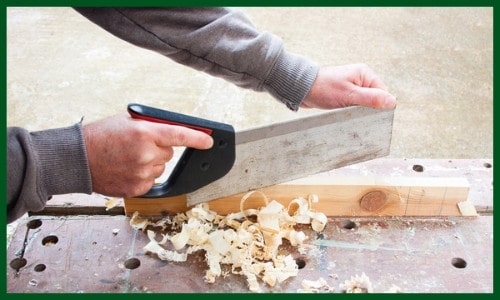 A woodworker using a tenon saw